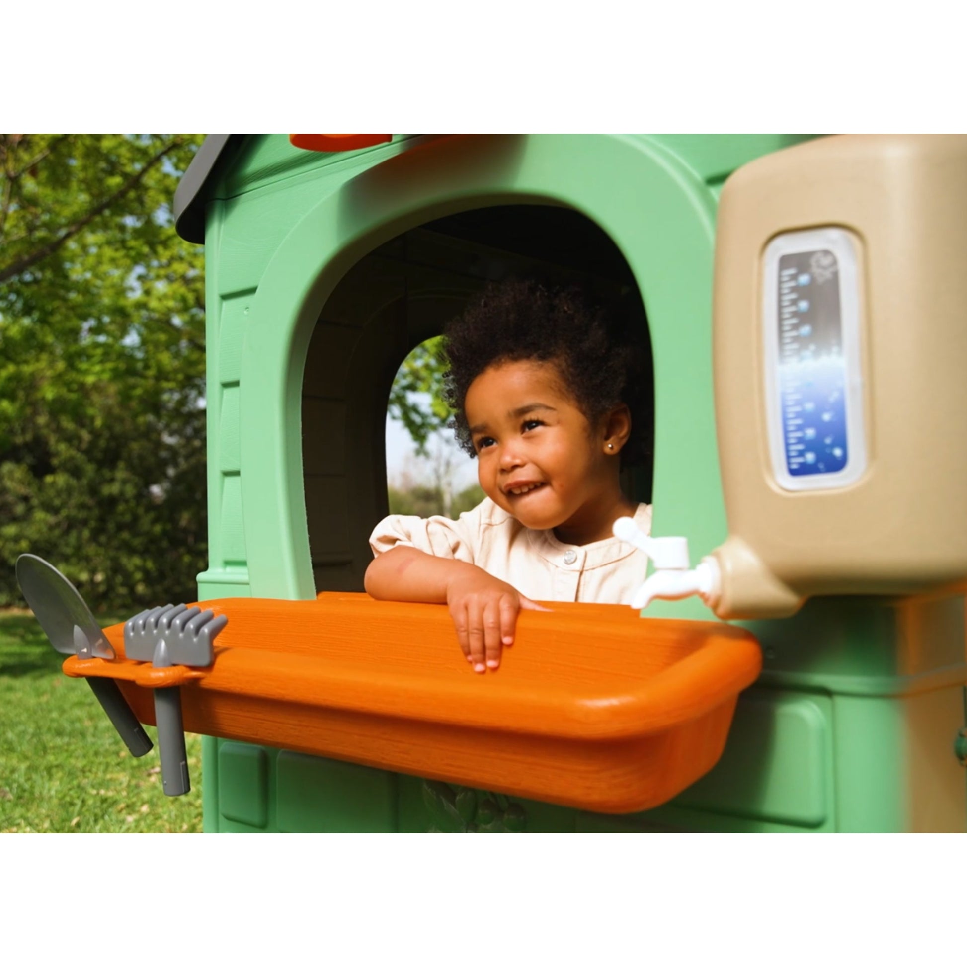 practical recycled eco playhouse with wind turbine and solar panels for kids to learn sustainability