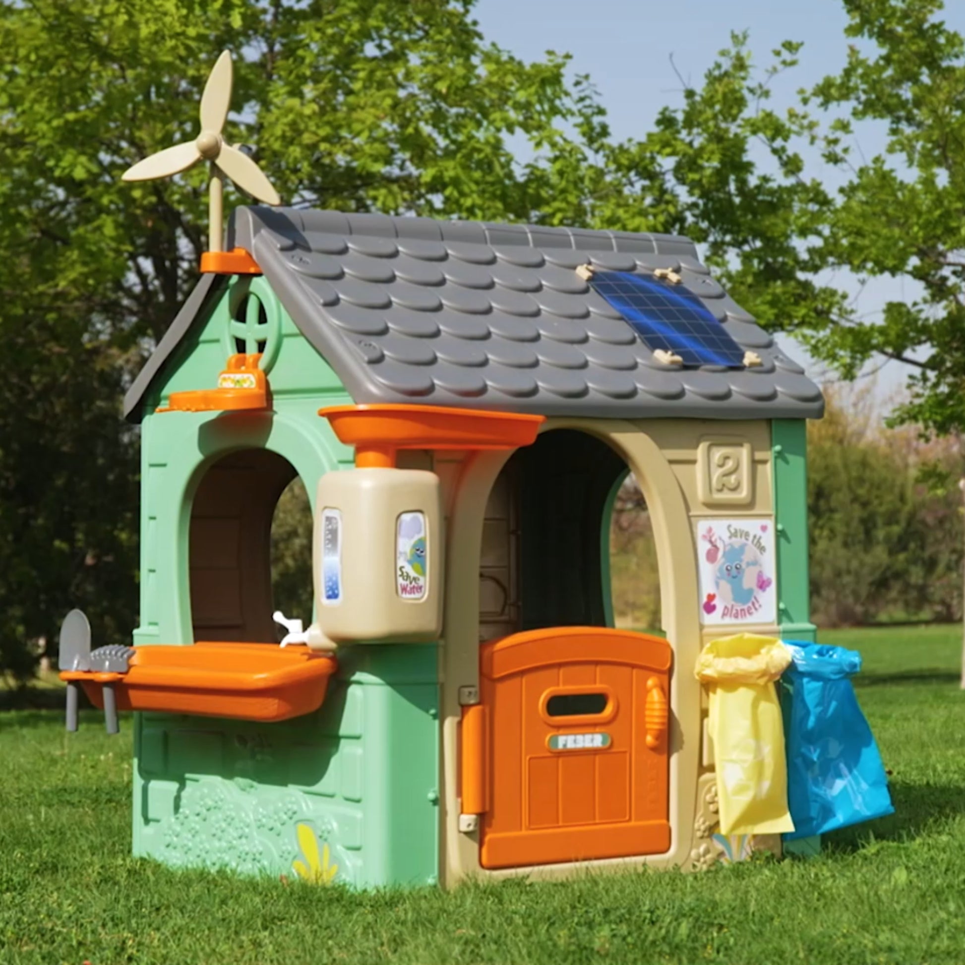 bold eco playhouse with wind turbine and solar panels teaching kids sustainability through play