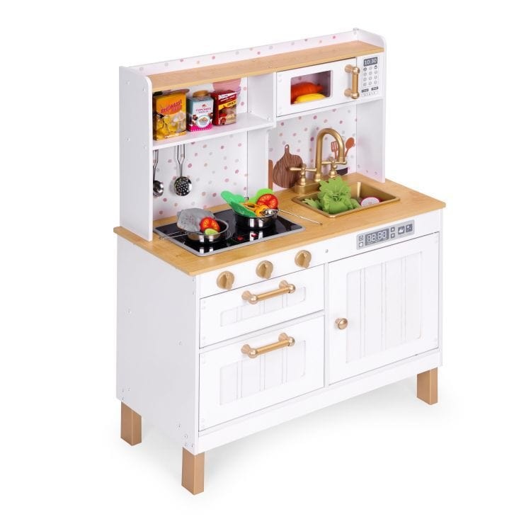a child's hands gently turning the knobs on a soft-lit wooden play kitchen