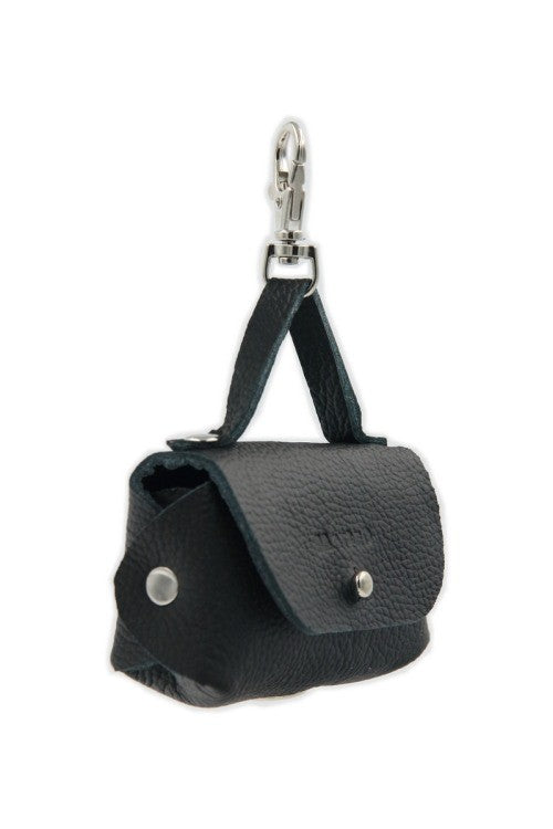 elegant black leather dog waste bag dispenser attached to a leash in soft light