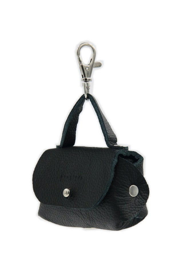 softly lit black leather dog bag dispenser with metal eyelet attached to a leash