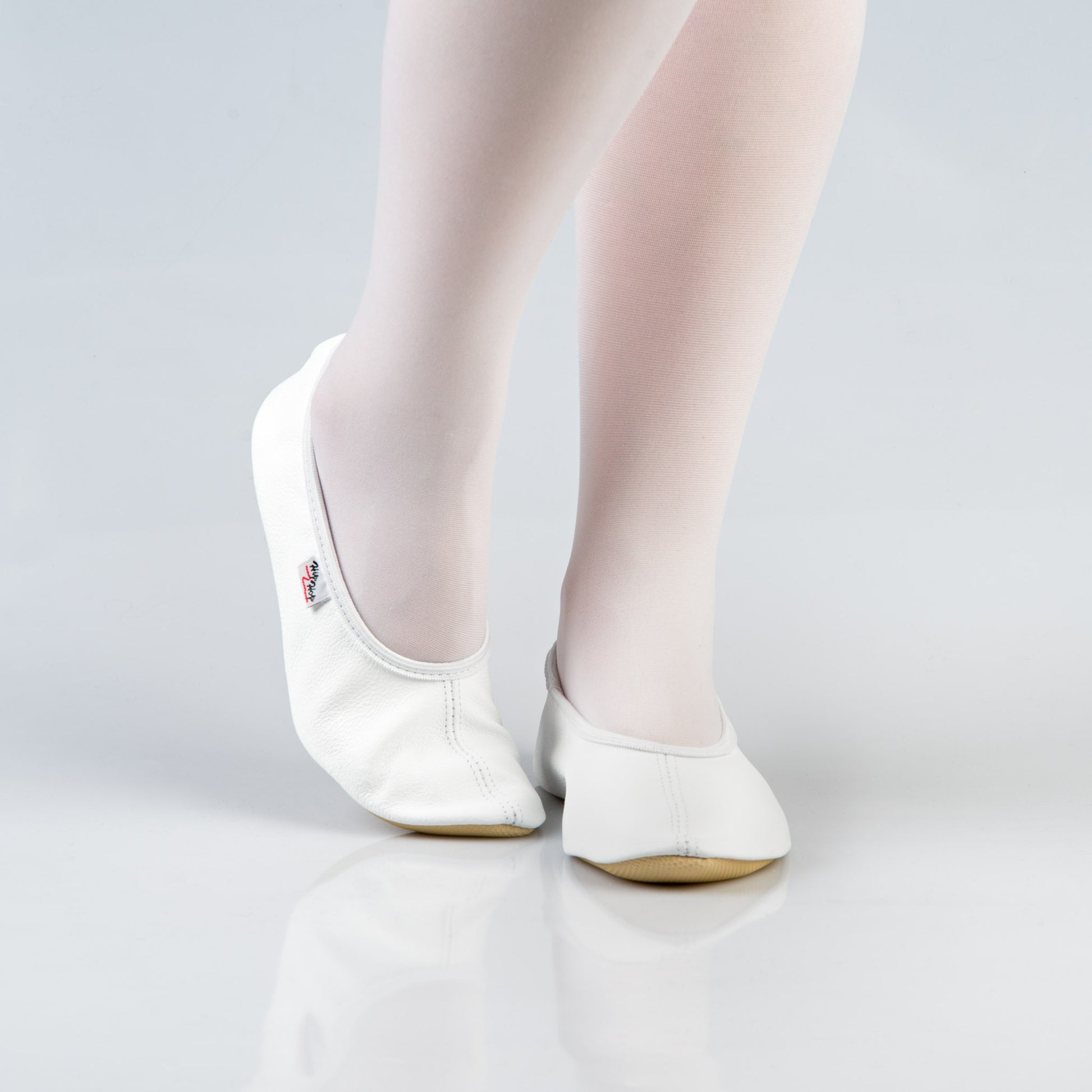 soft white leather gymnastics slipper with a secure rubber ridge and sole for comfort