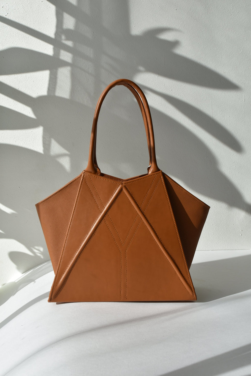 elegant gerda retter leather tote bag with magnetic closure in warm studio lighting