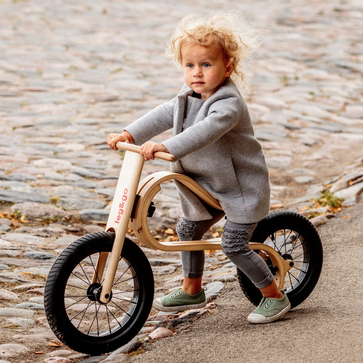 elegant birch balance bike in a refined home setting, showcasing its smooth curves and minimalist design
