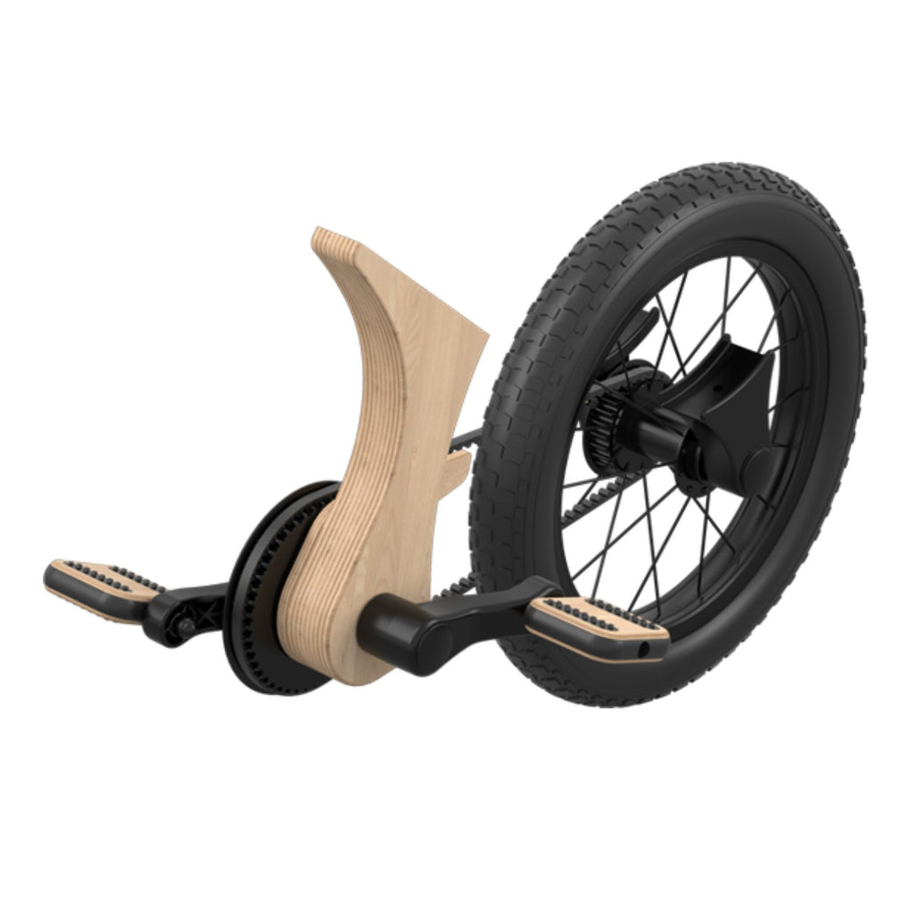 a child's wooden pedal conversion kit with a clean belt drive, shown in soft morning light