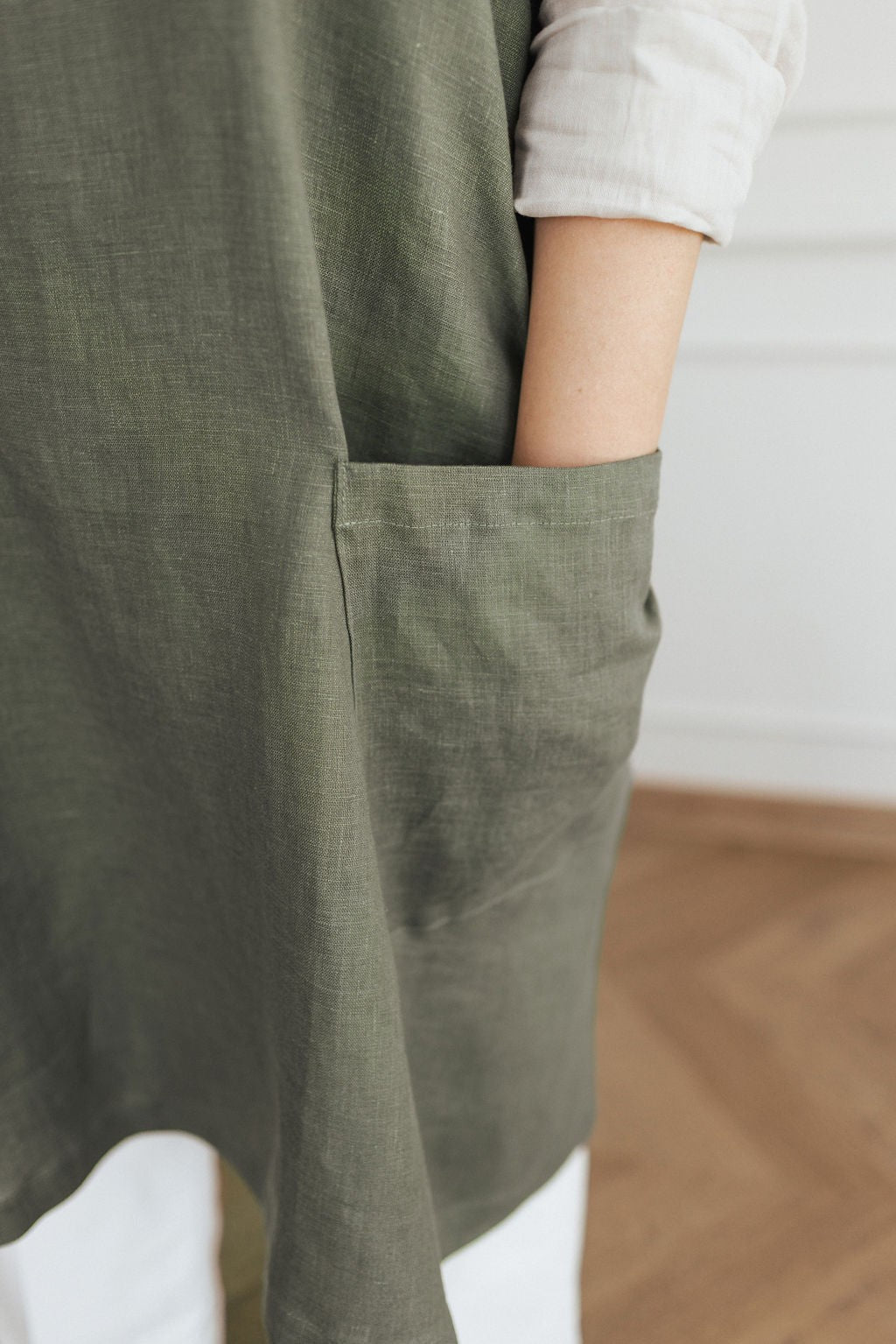 soft linen apron with crossed back straps in warm morning light