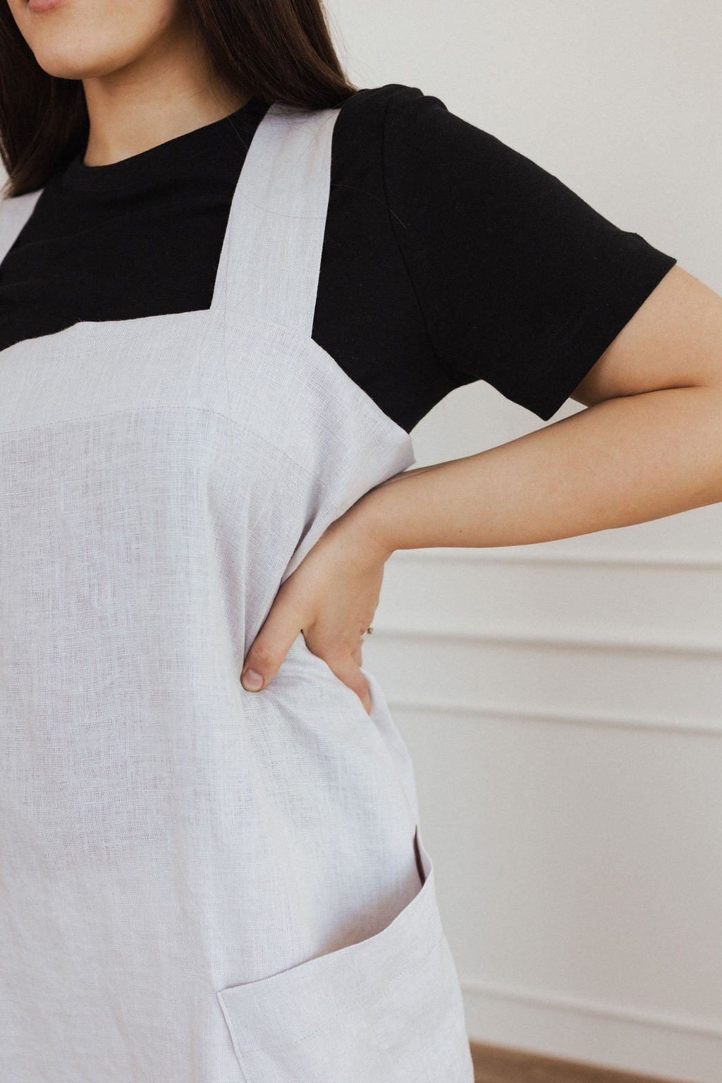 handmade linen apron with two deep pockets, shown in warm morning light on a rustic wooden table