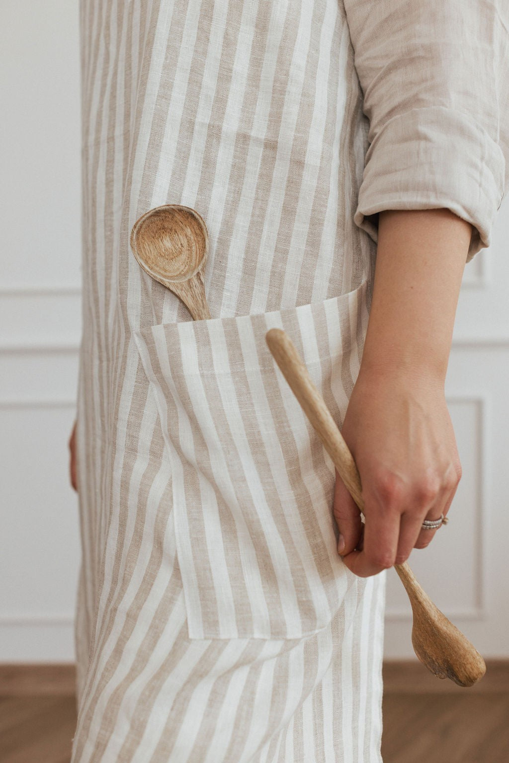 elegant linen apron with crossed back straps in a warm, natural light setting