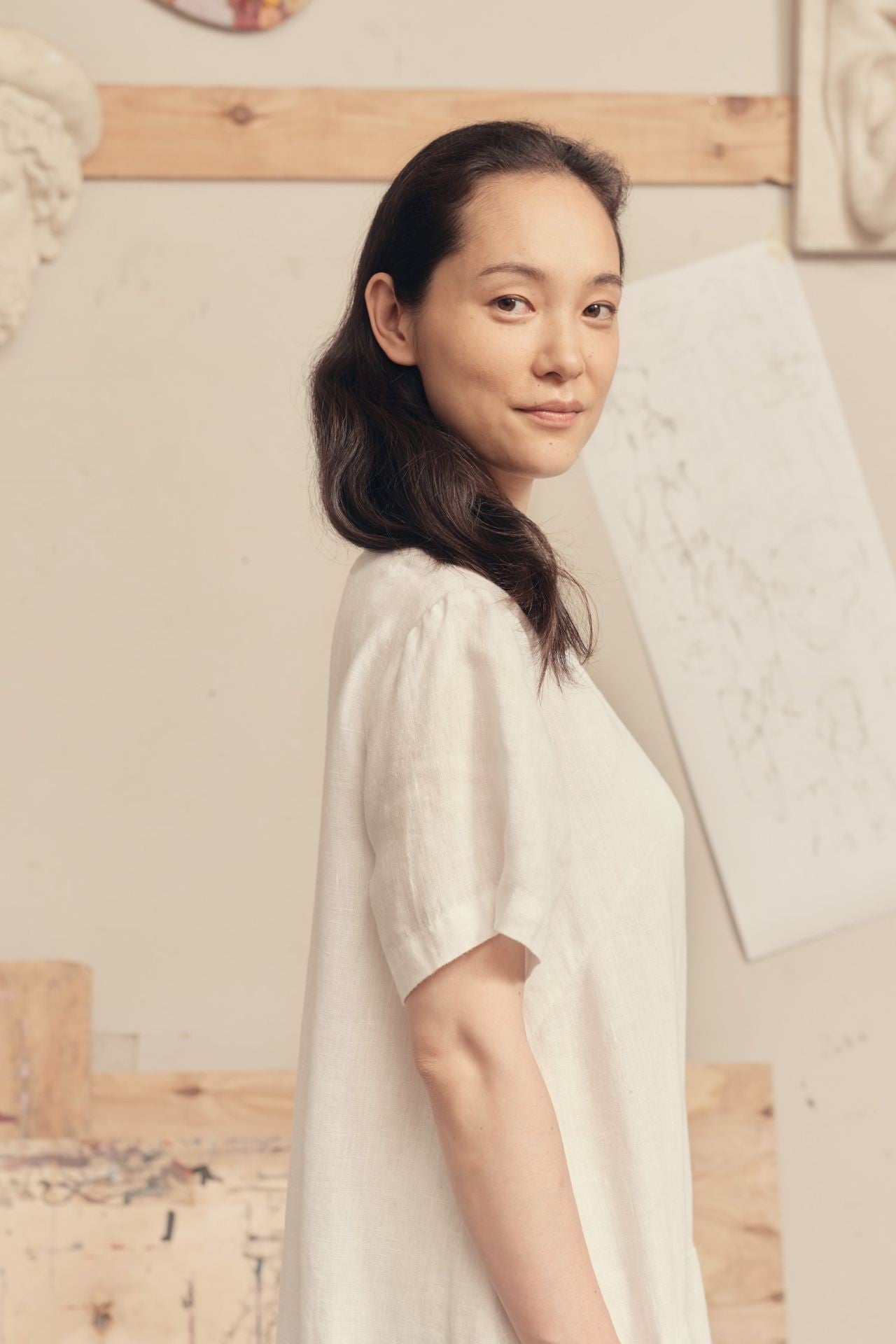 playful twirl in a breezy white linen dress with handy front pockets