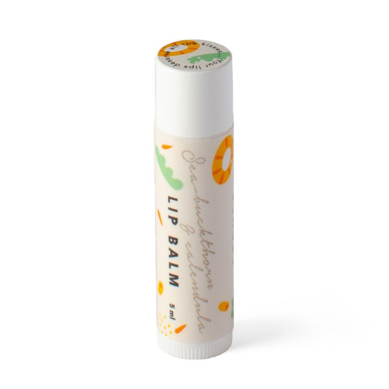 a soothing sea buckthorn and calendula lip balm resting on soft fabric