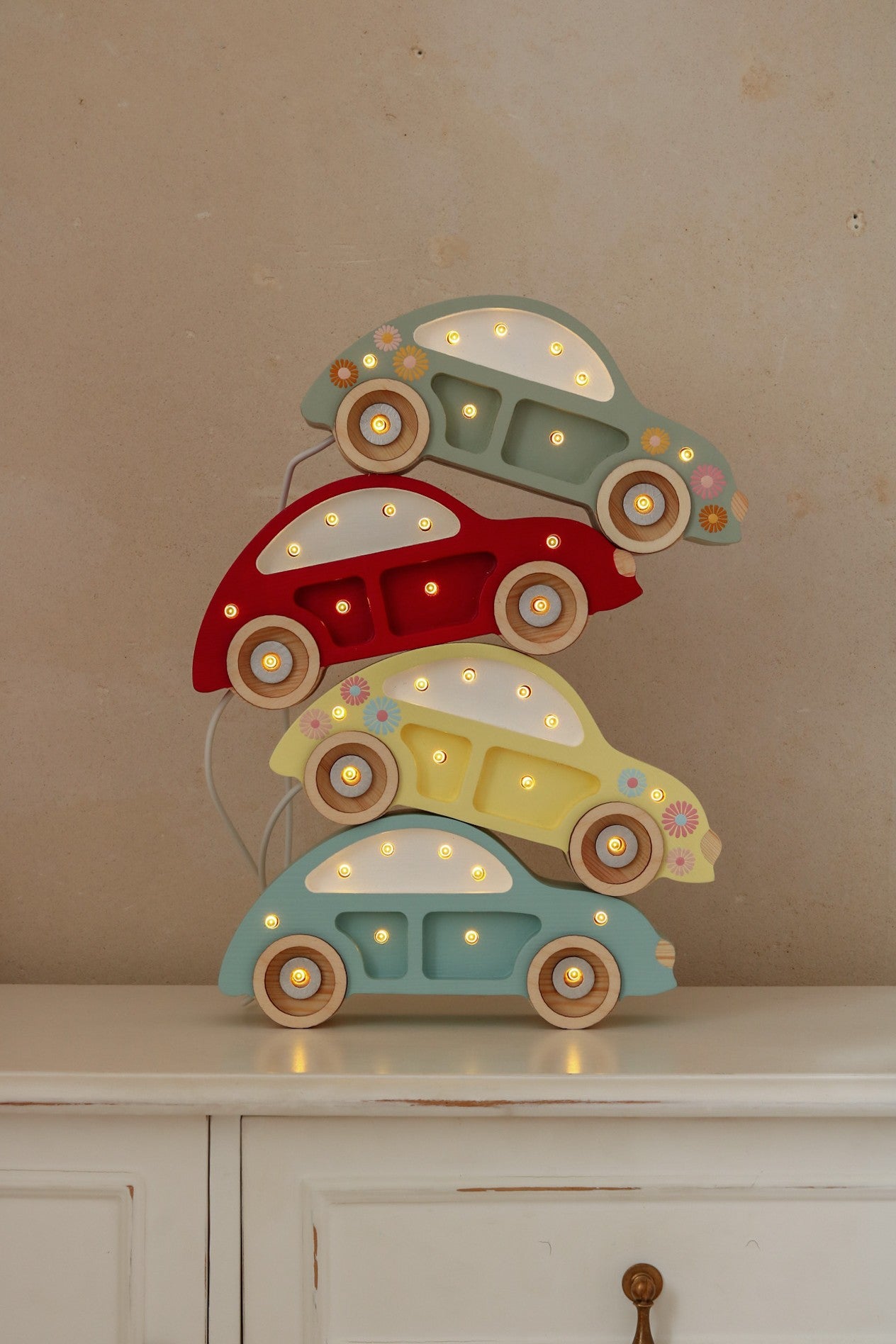 close-up of the beetle car mini lamp's warm led glow on a pinewood nightstand