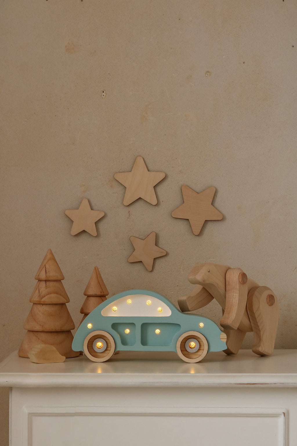 a close-up of the beetle car lamp's warm led glow on a pinewood nightstand