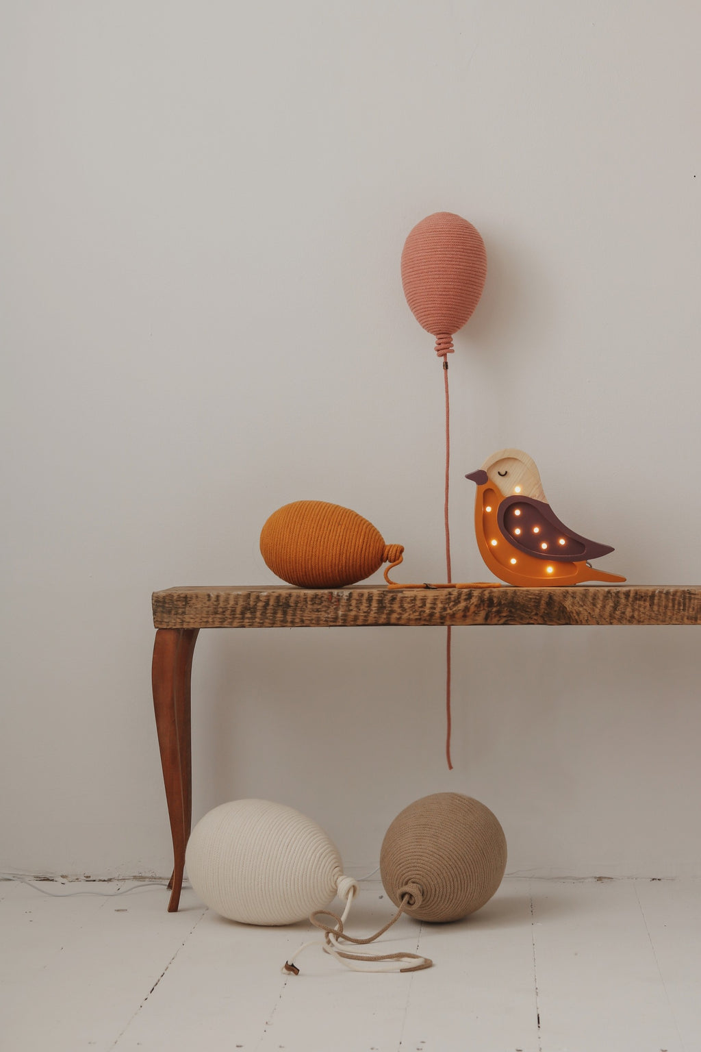 handmade pine wood bird lamp casting a soft glow on a childs nightstand