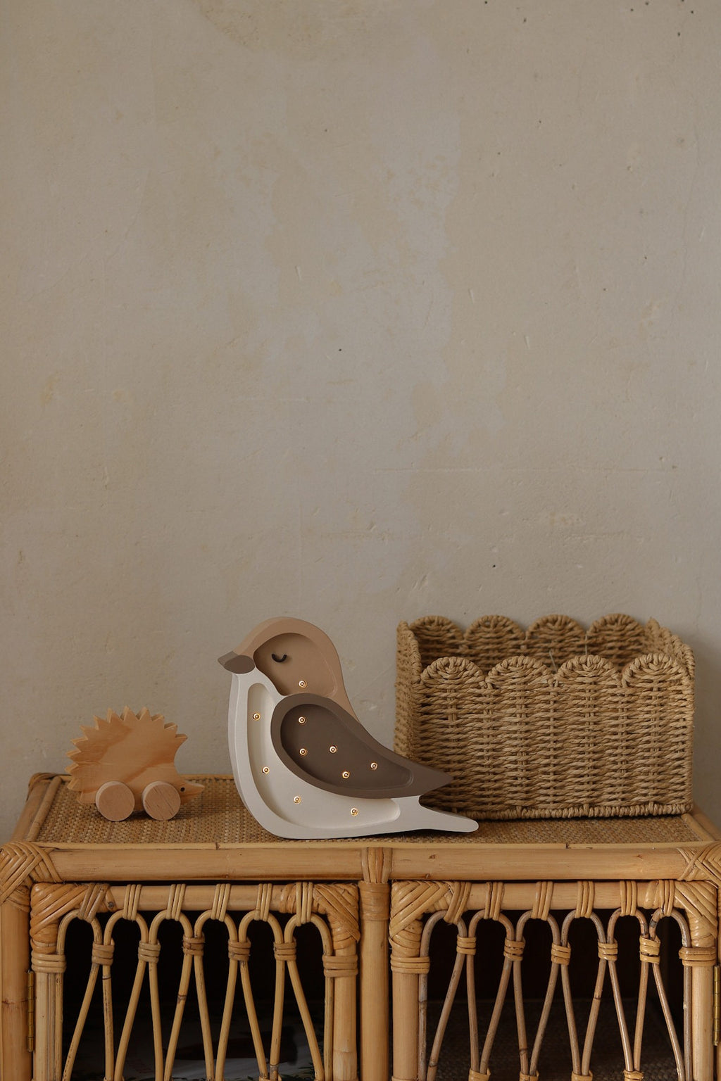 handmade pine wood bird lamp casting a soft glow on a nursery shelf