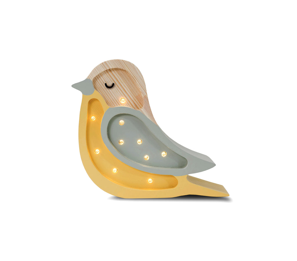 handmade pine wood bird lamp casting a soft glow on a childs bedside table