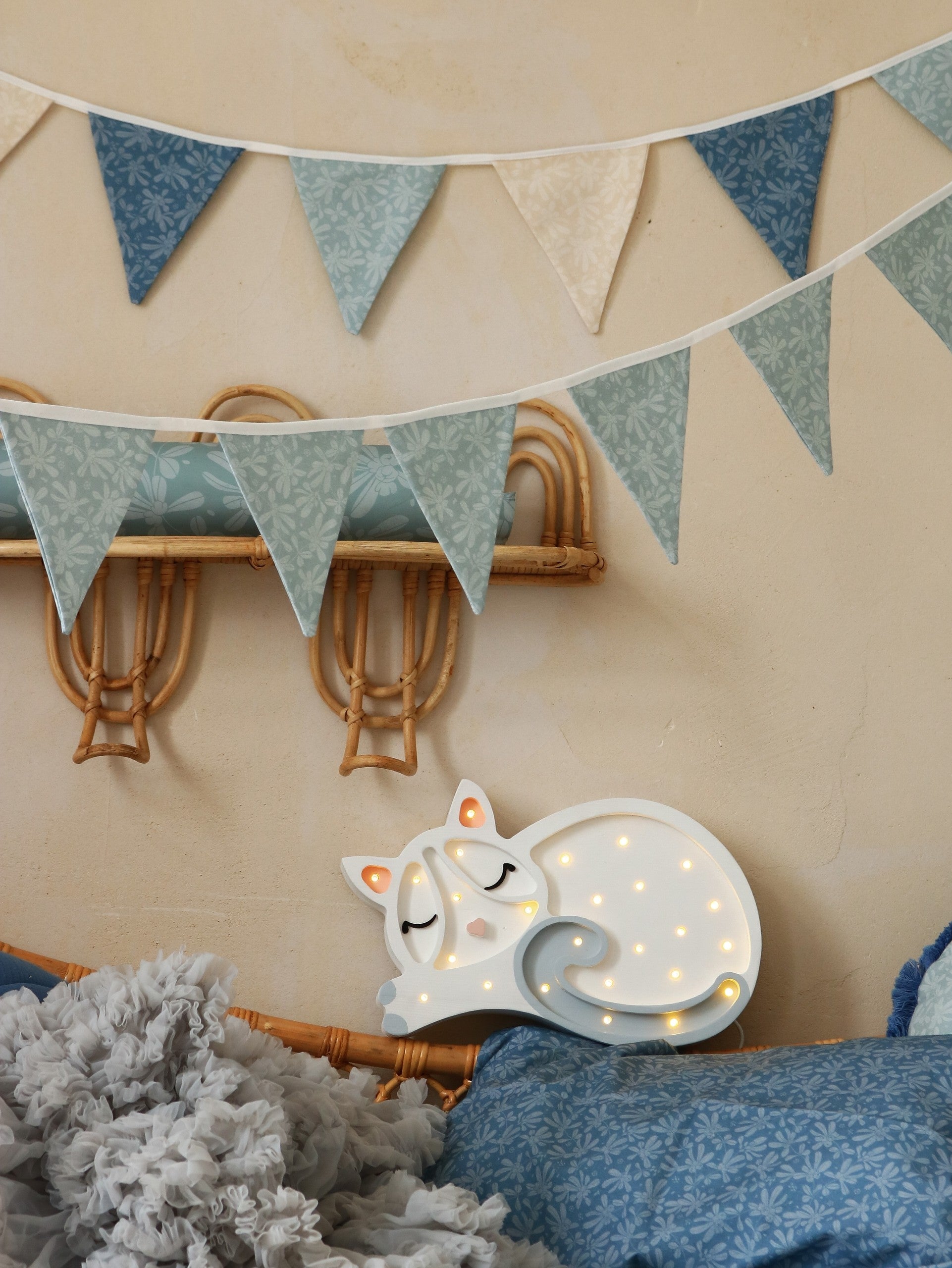 a soft glowing cat lamp casting a warm, comforting glow in a child's cozy bedroom