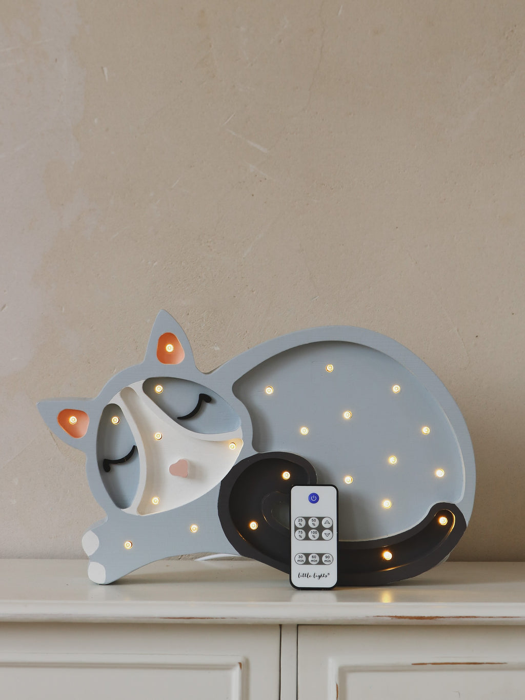 playful little lights cat lamp casting a warm glow on a child's bedside table