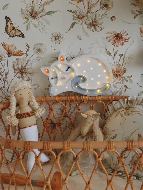 a child's hand adjusting the dimmer on a handmade pine wood cat night light