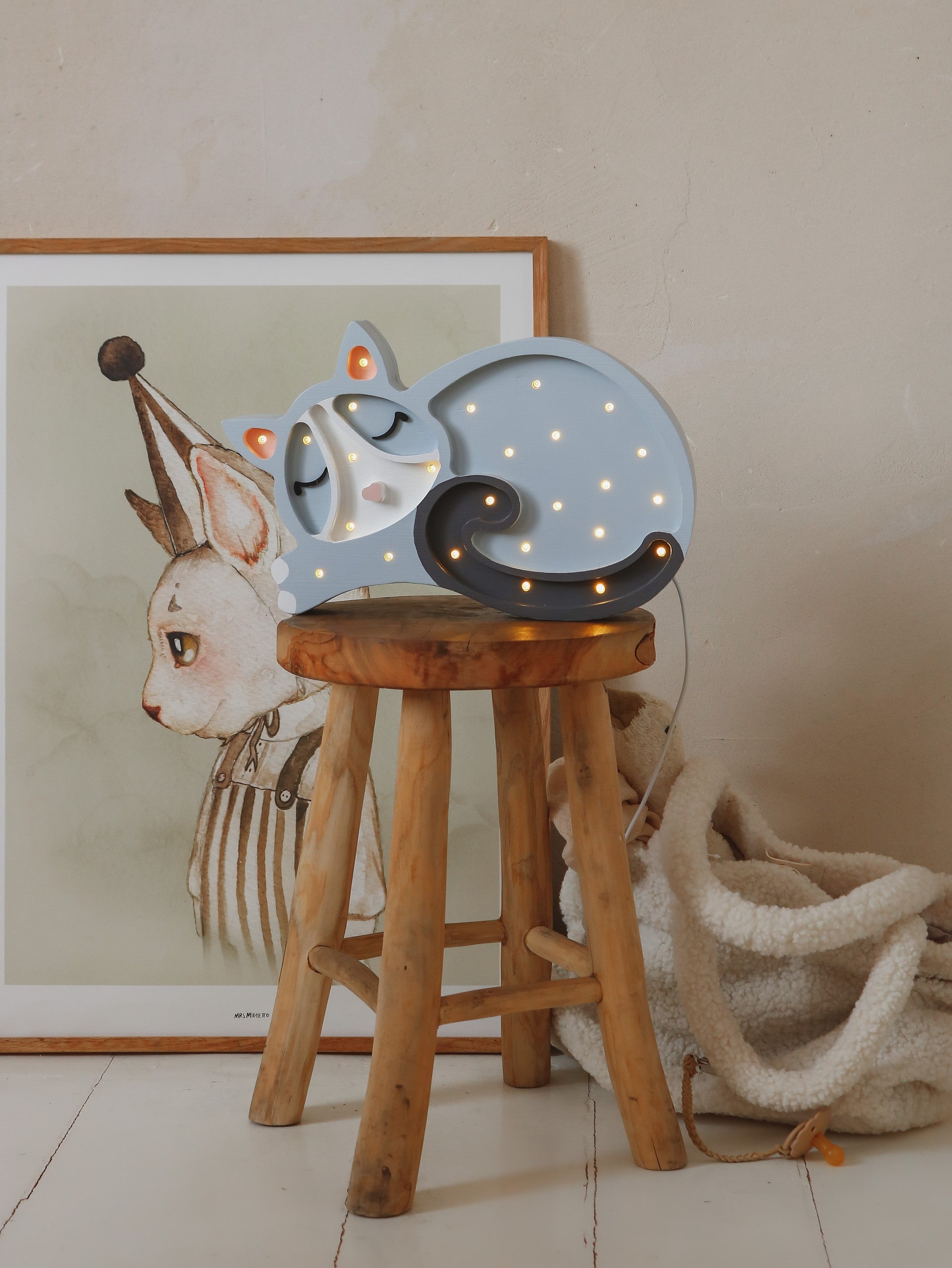 handcrafted pine wood cat lamp casting a warm glow in a child's room