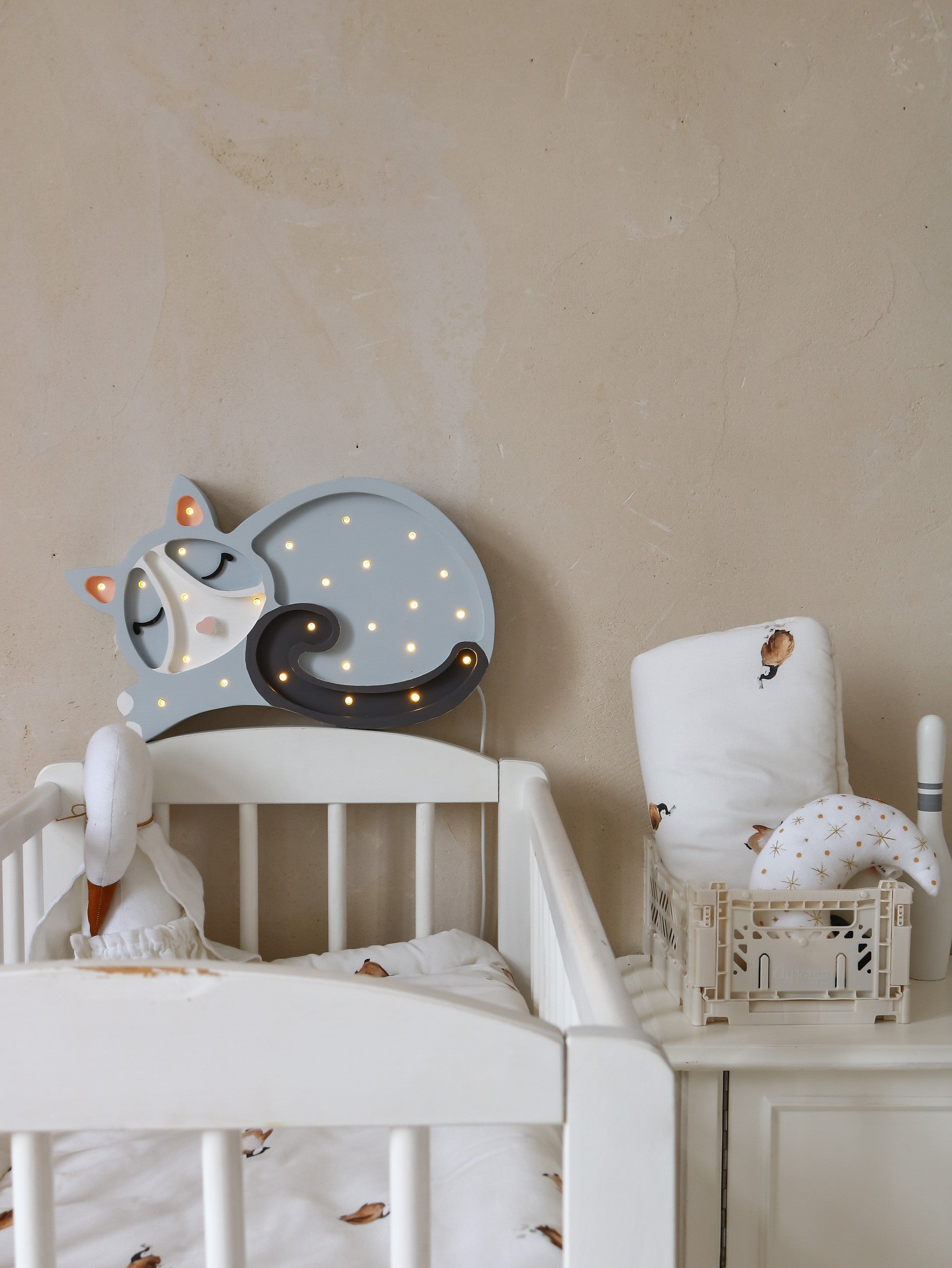 handcrafted pine wood cat lamp casting a warm glow in a cozy nursery