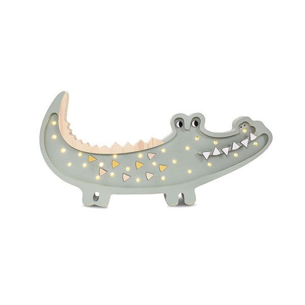 playful crocodile lamp casting a warm glow on a child's bedside table during story time