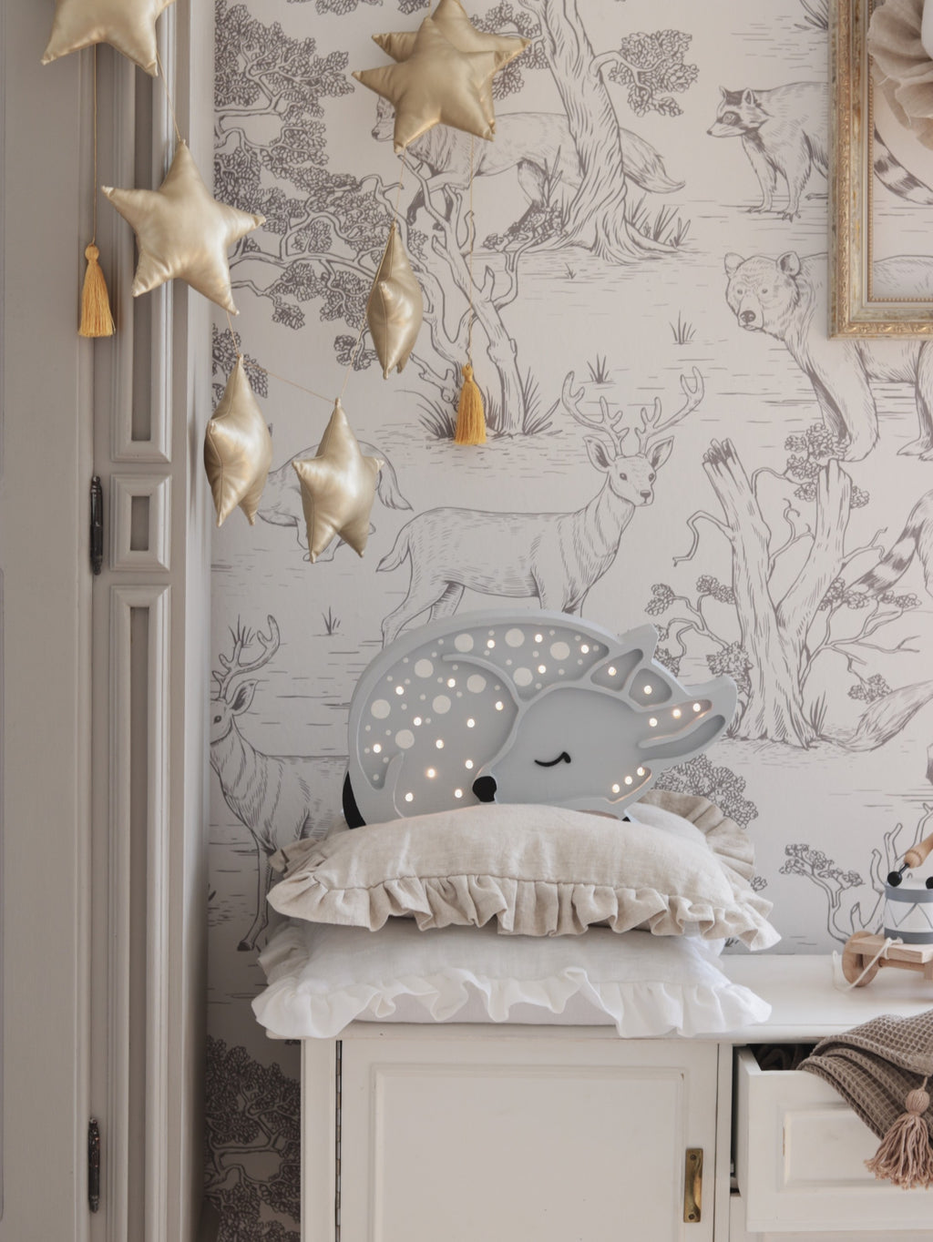 playful little lights deer lamp casting a warm glow on a colorful toy shelf