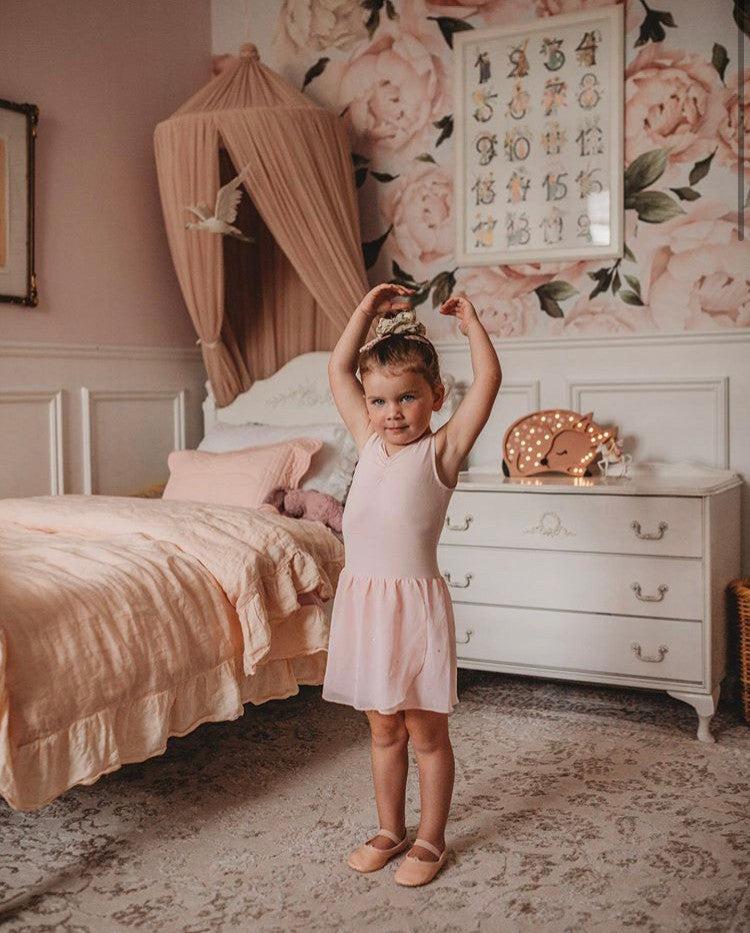 a child's hand gently touching the warm glow of a handmade pinewood deer nightlight