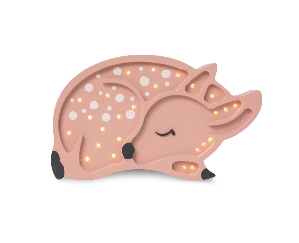 handcrafted pinewood deer lamp casting a warm glow on a bookshelf