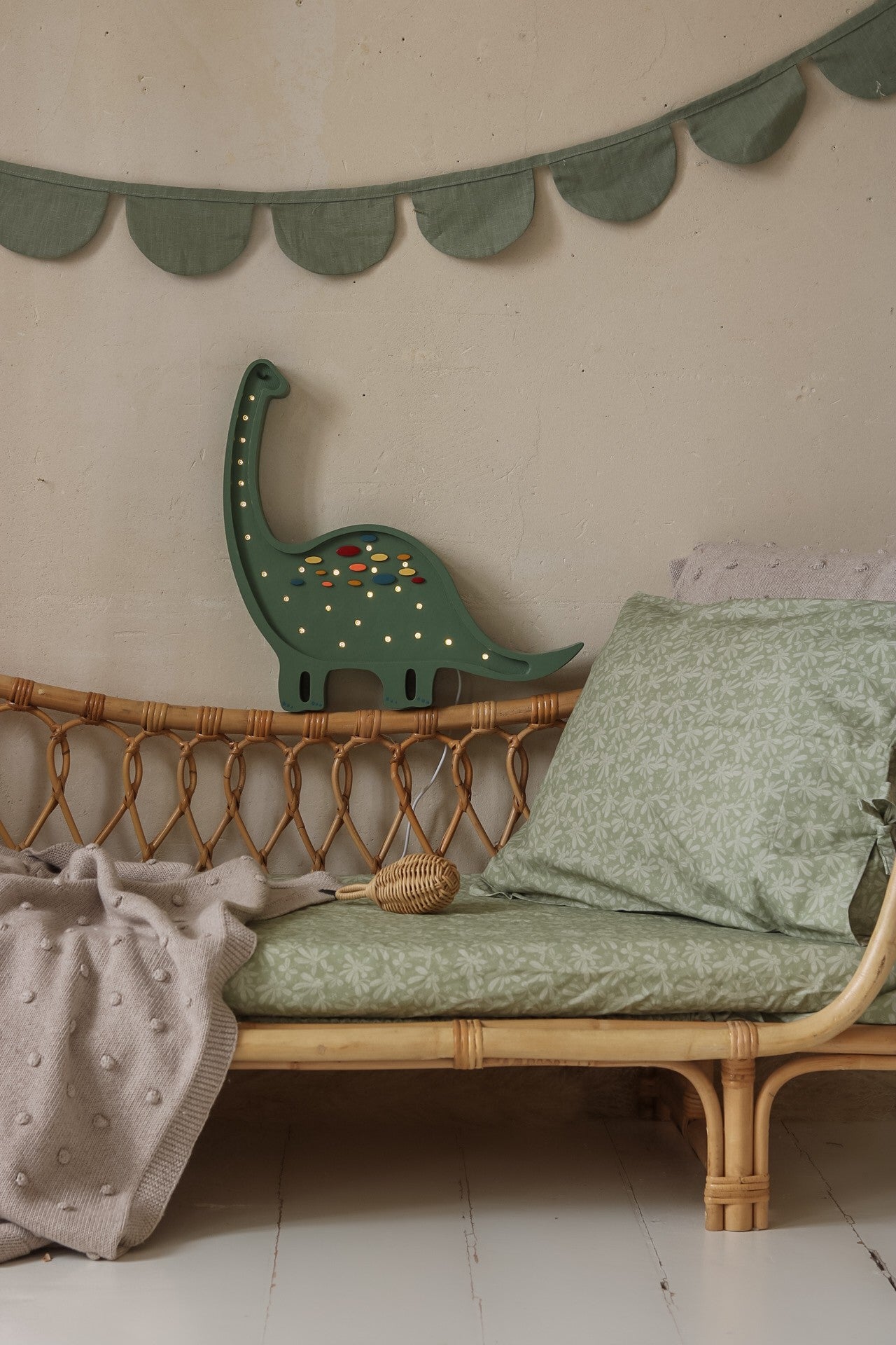 elegant diplodocus lamp in warm glow, highlighting its refined pine wood craftsmanship and gentle light