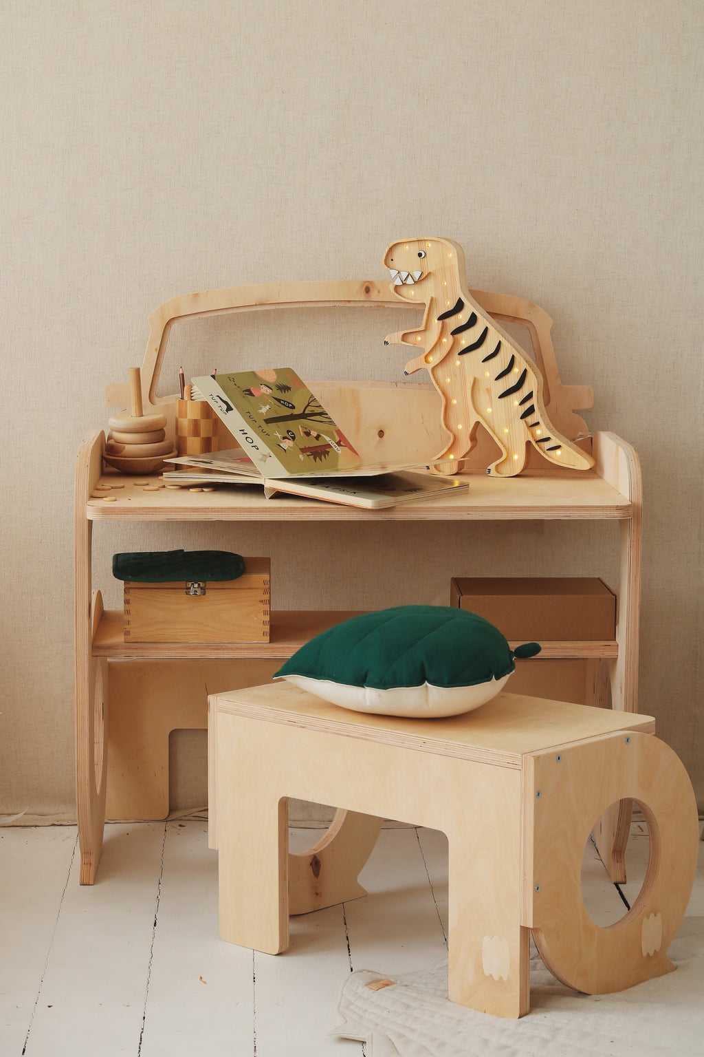 elegant profile of a handcrafted t-rex lamp casting a refined warm glow on a nightstand