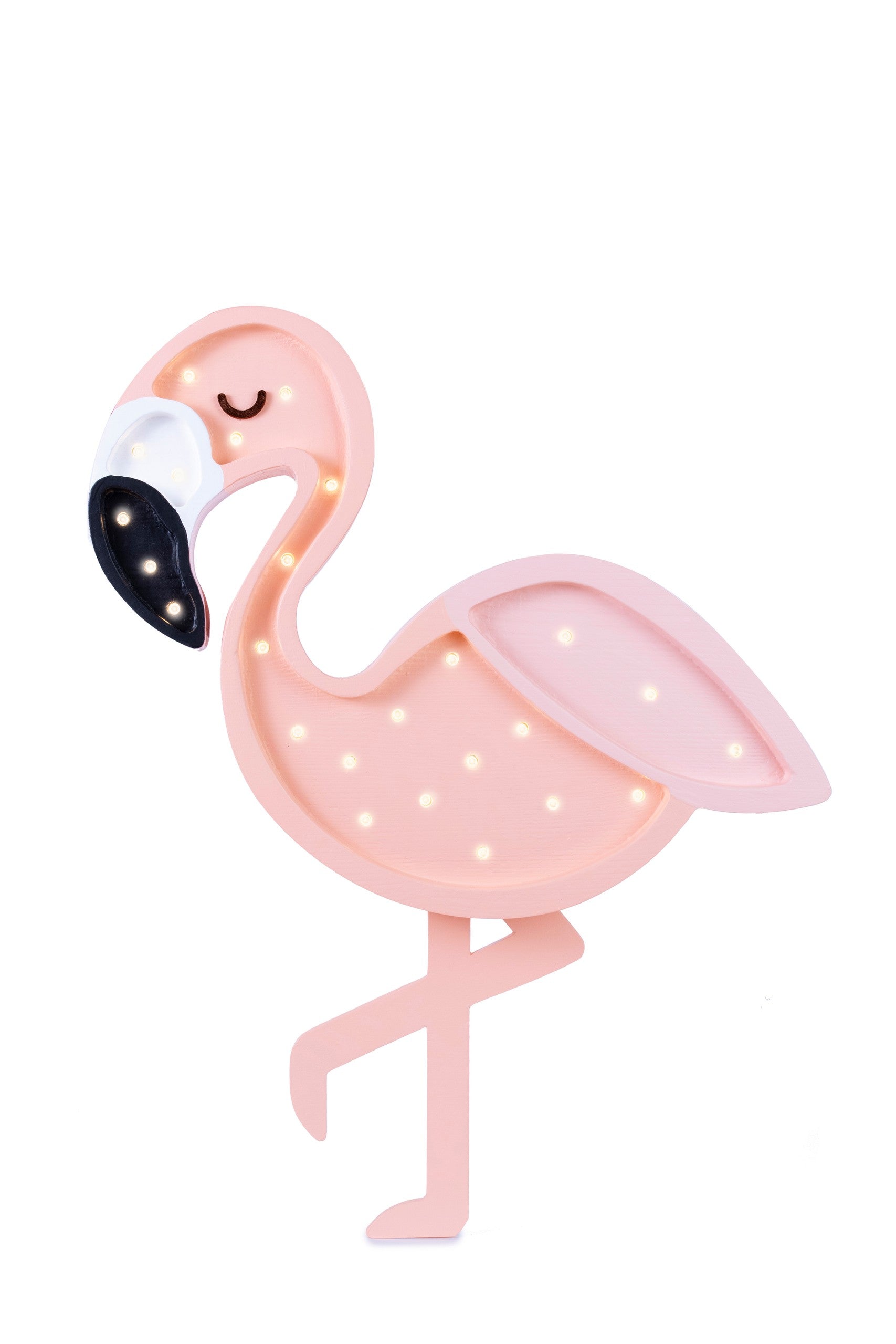 a soft warm glow from the handcrafted flamingo night light on a nursery shelf