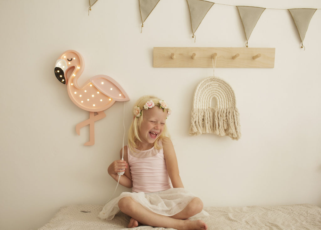 playful pink flamingo night light casting a fun glow on a childs bedside table