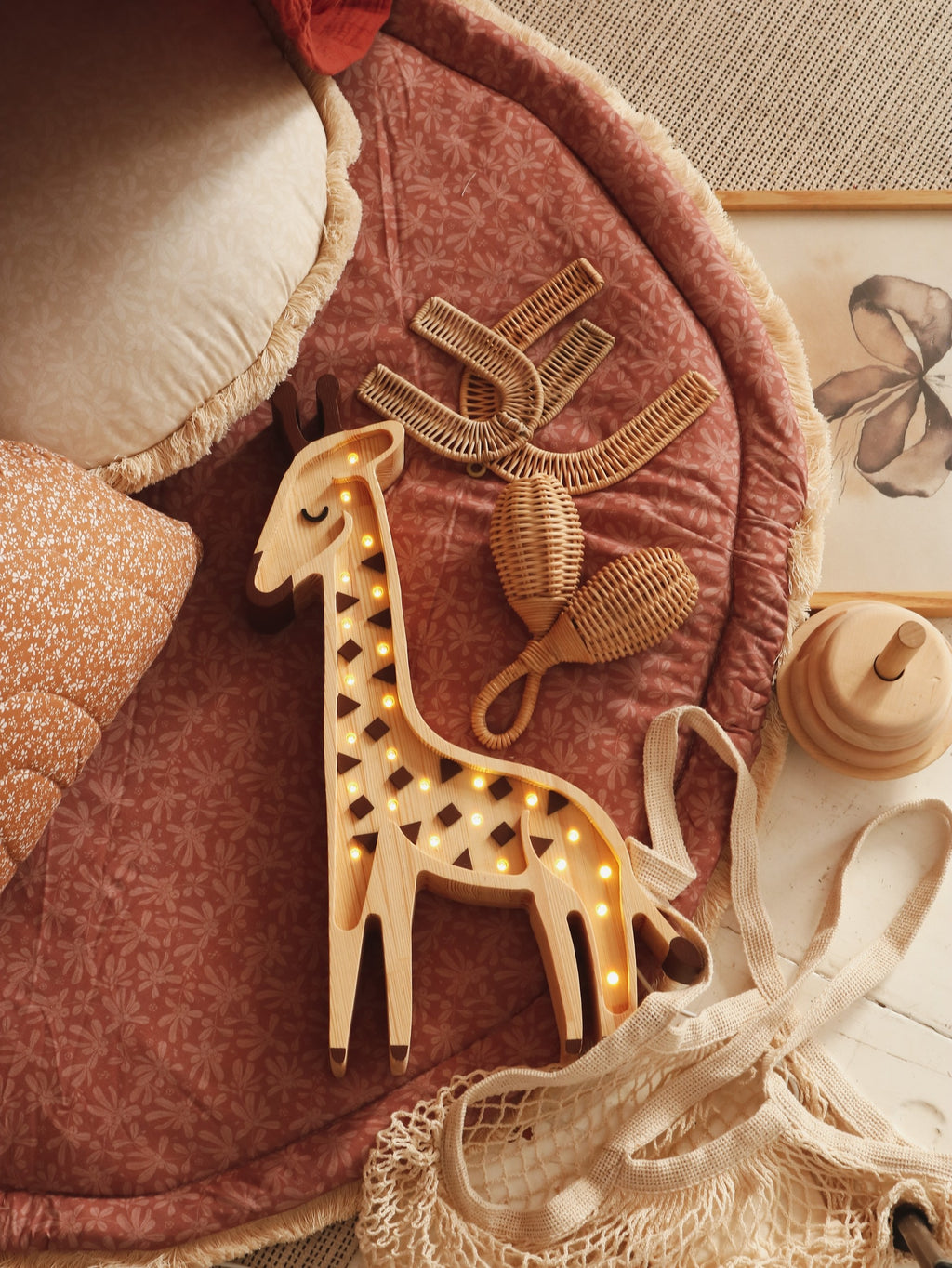 elegant solid pinewood giraffe lamp casting a refined warm glow in a nursery