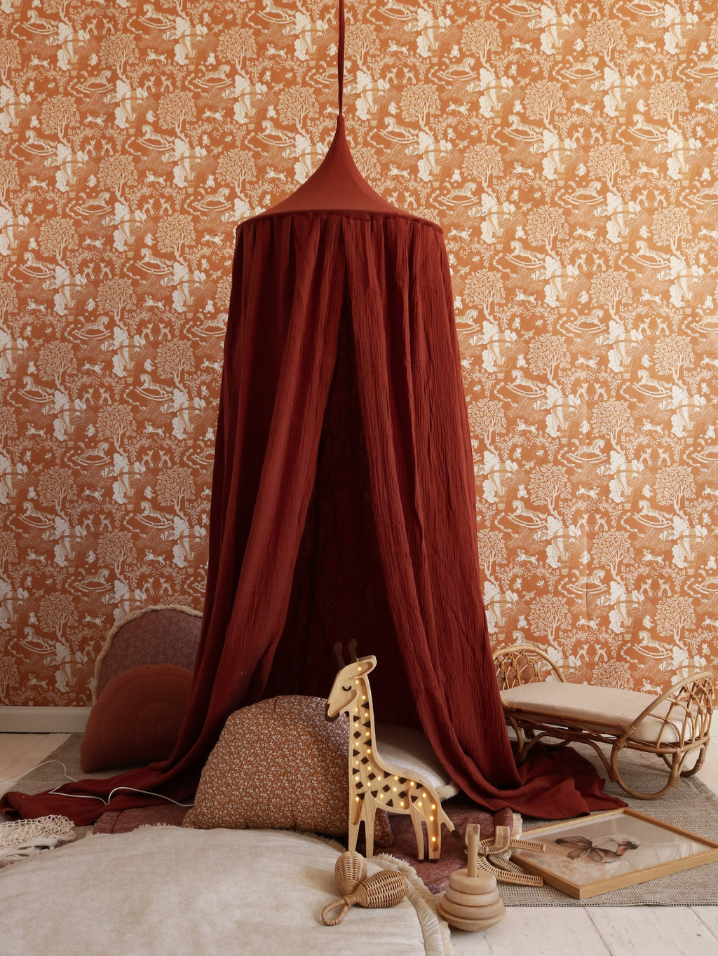 functional giraffe lamp on a pinewood nightstand showing its remote control and cord switch