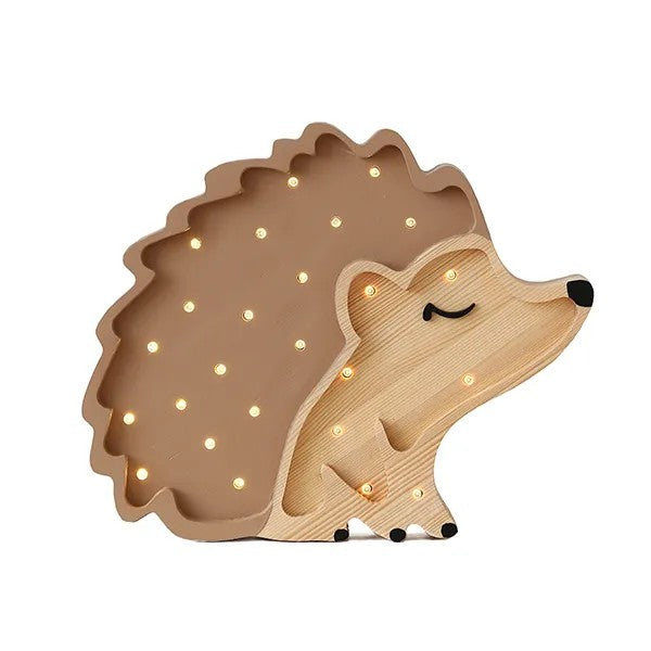 bold artisan-made hedgehog night lamp glowing warmly on a dark wood surface