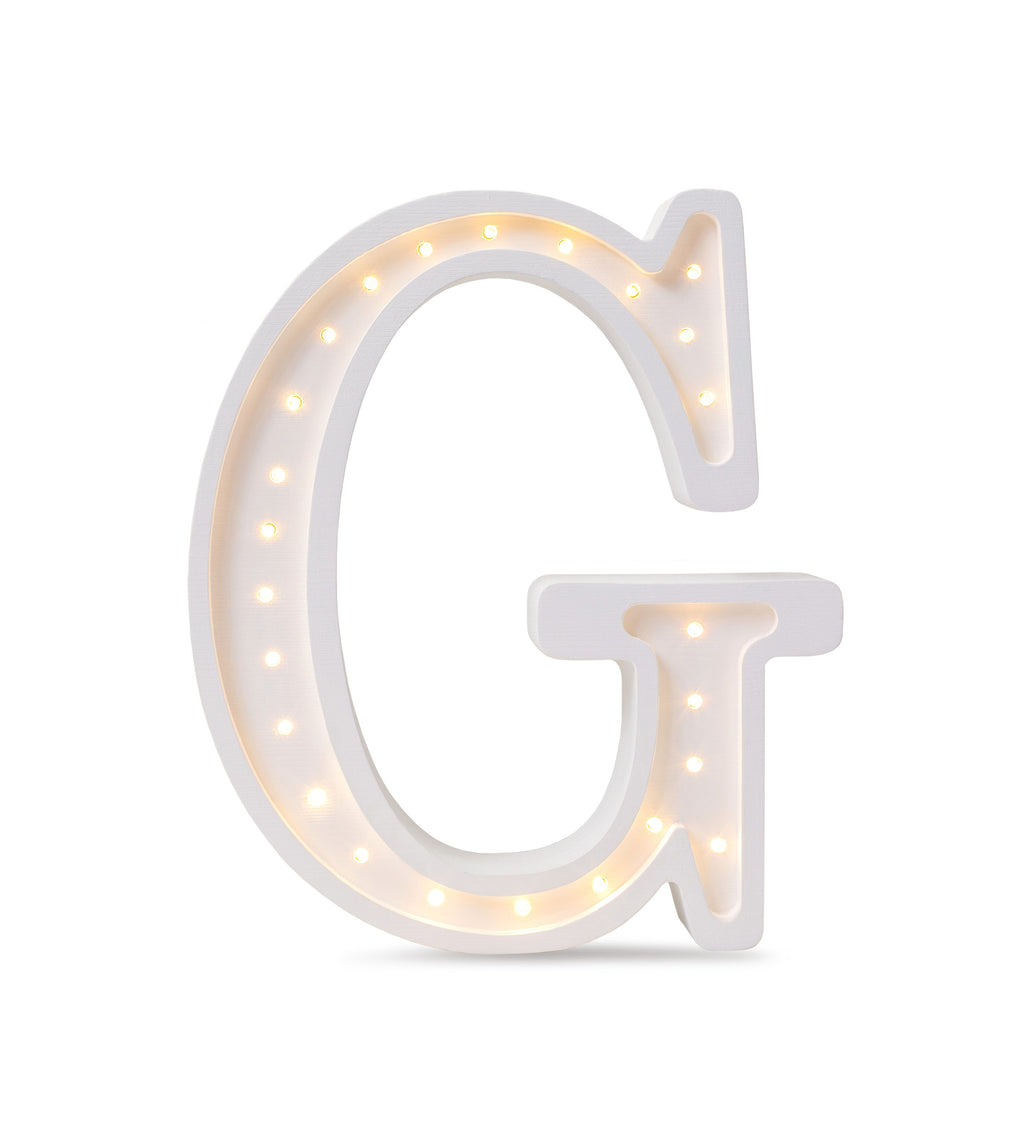 softly glowing wooden letter g lamp casting a warm comforting light on a nightstand