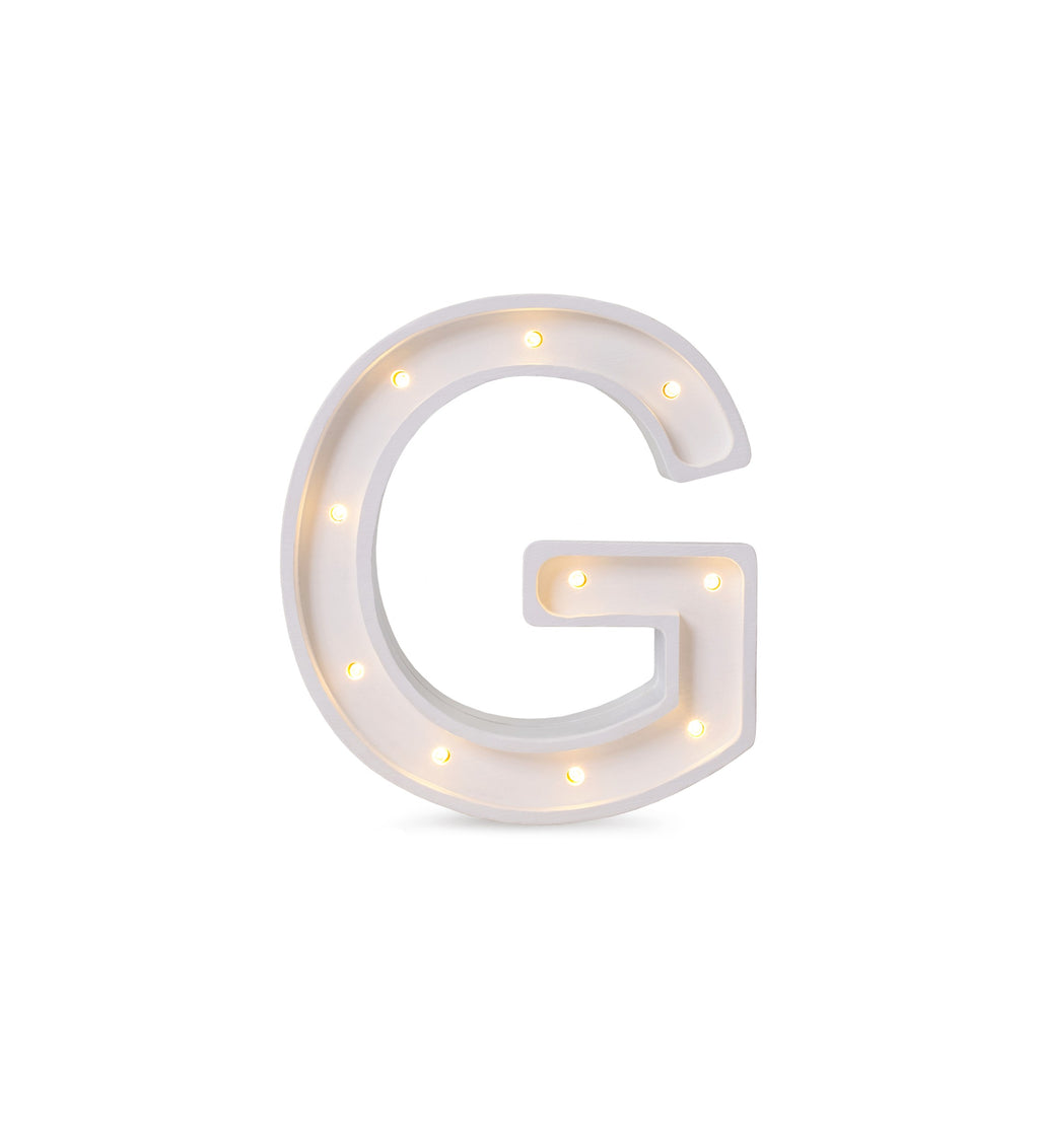 bold solid pinewood letter g lamp glowing warmly in a childs room at night