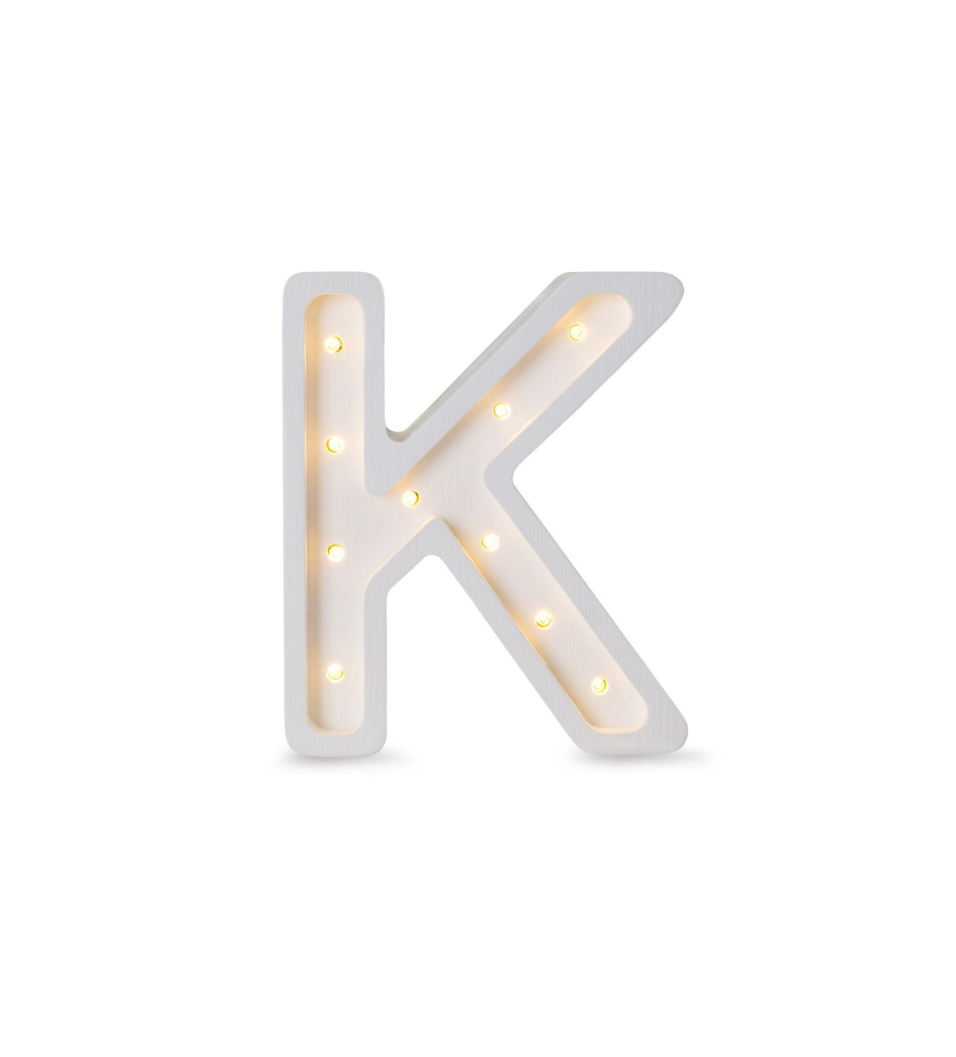 bold solid pinewood letter k lamp glowing with warm led light in a dark room