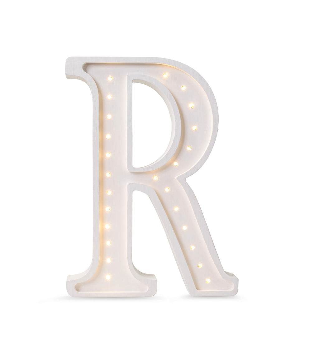 a soft-glow letter r lamp casting a warm, comforting light on a nursery shelf