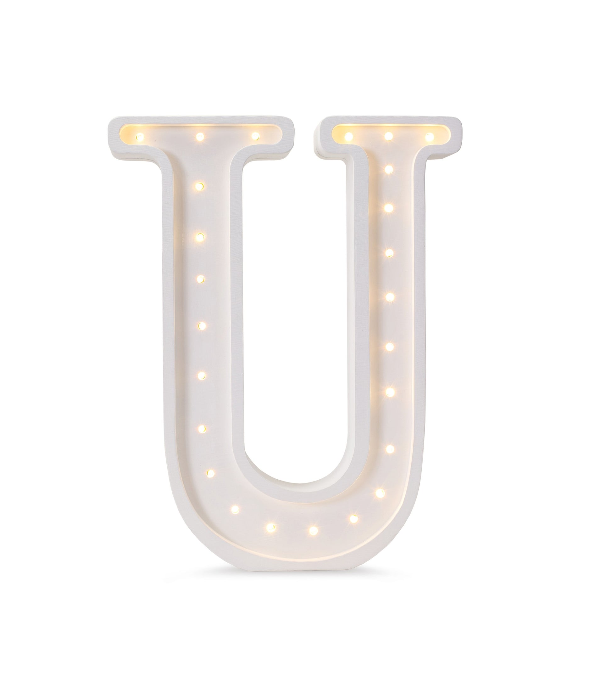 handcrafted wooden u letter lamp casting a soft warm glow on a nursery shelf