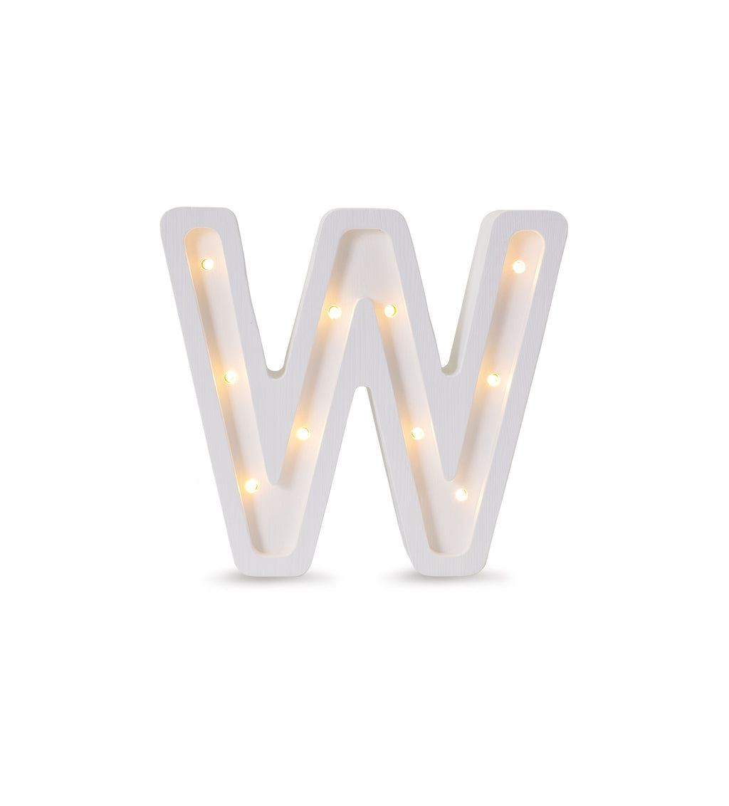 bold solid pinewood letter w lamp glowing warmly in a modern nursery