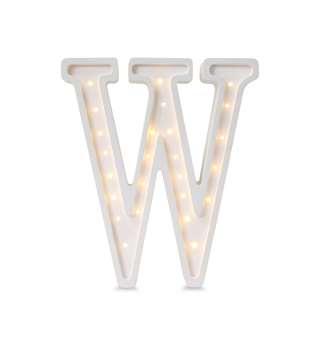 a playful close-up of the w letter lamp glowing on a colorful toy shelf