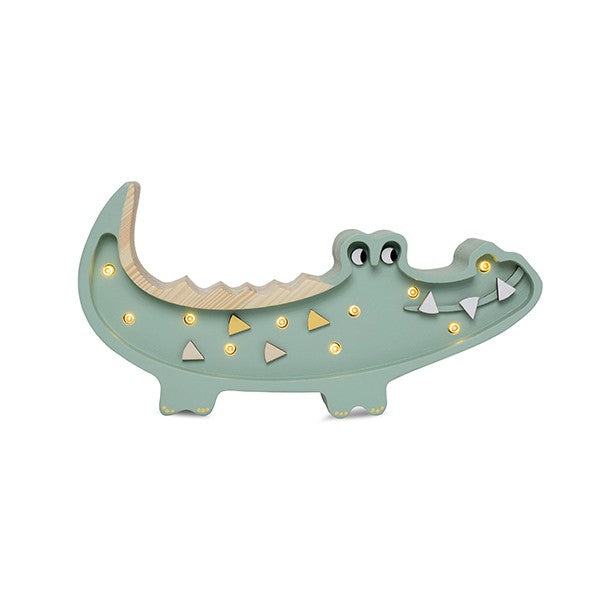 handmade pine wood crocodile lamp on a nursery shelf casting a soft warm glow for bedtime