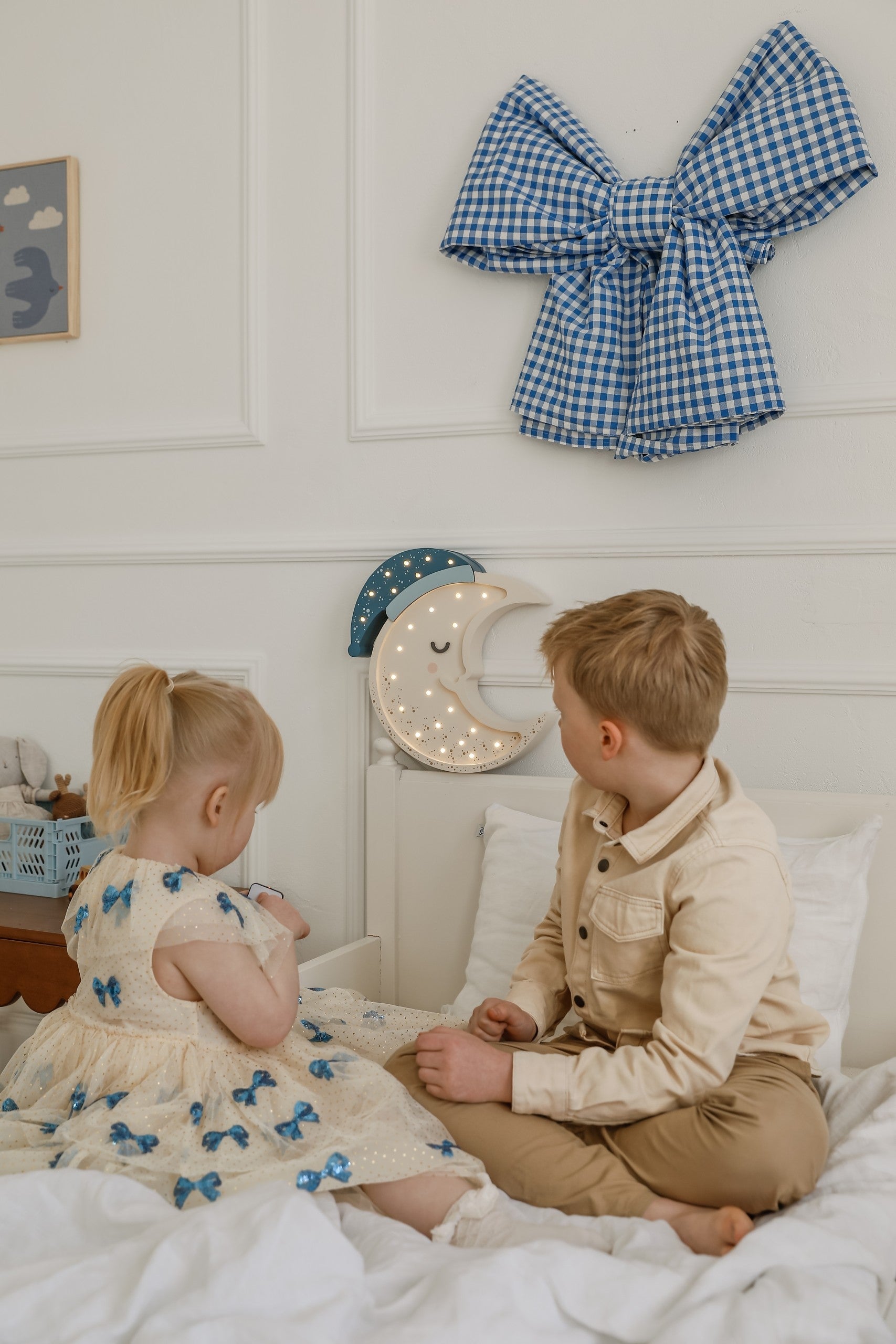 a playful close-up of the moon lamp's warm glow on a child's bedside table
