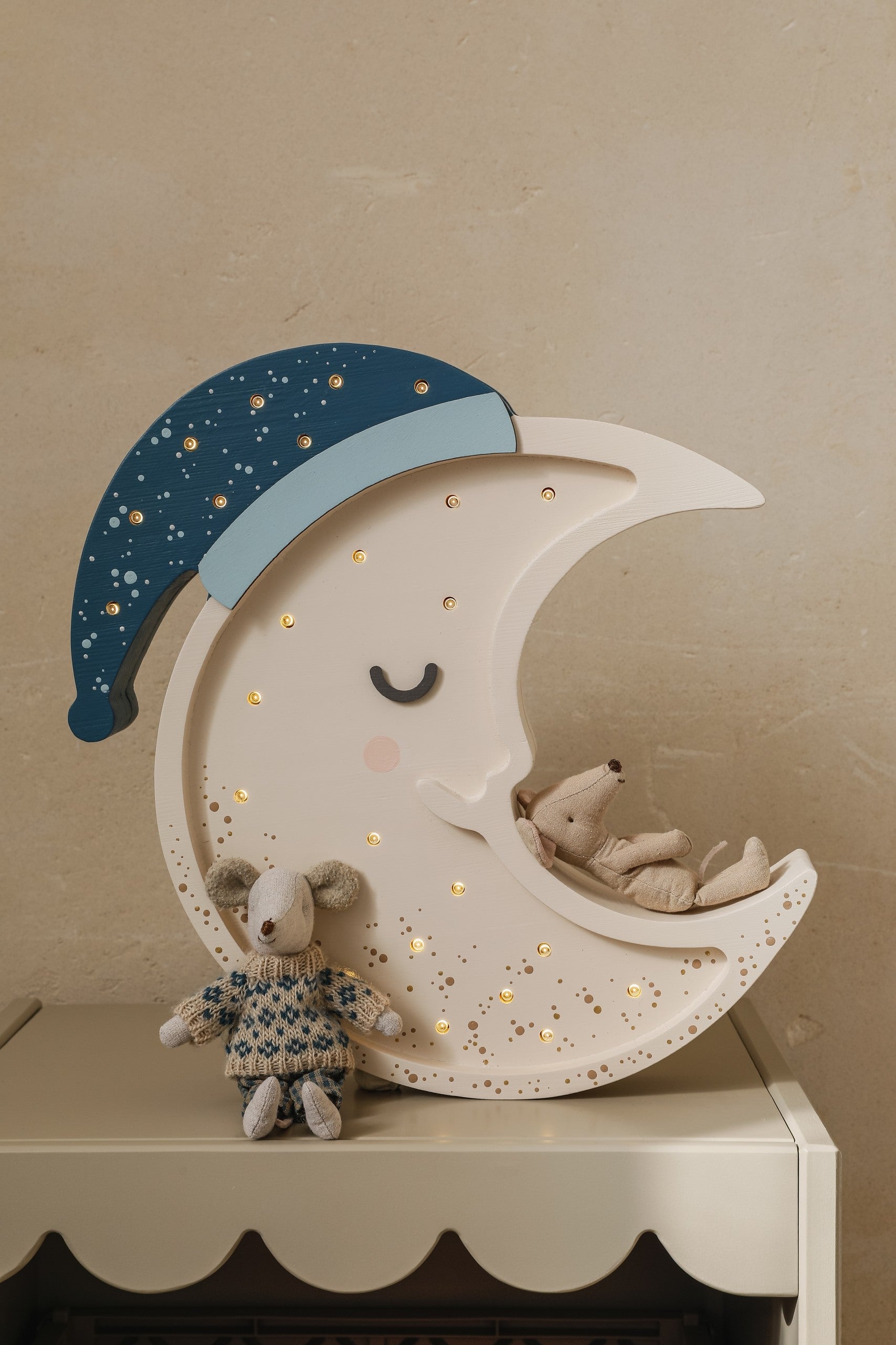 handcrafted pinewood moon lamp casting a soft glow on a childs bedside table