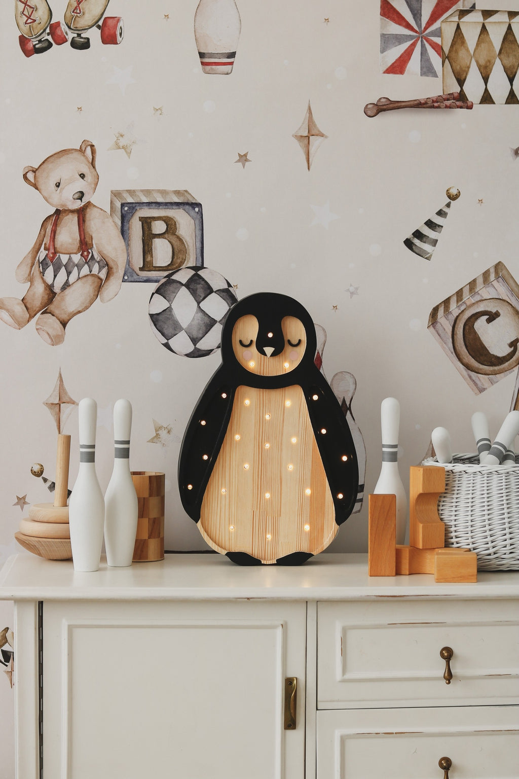 handcrafted pinewood penguin lamp casting a warm, gentle glow on a child's nightstand