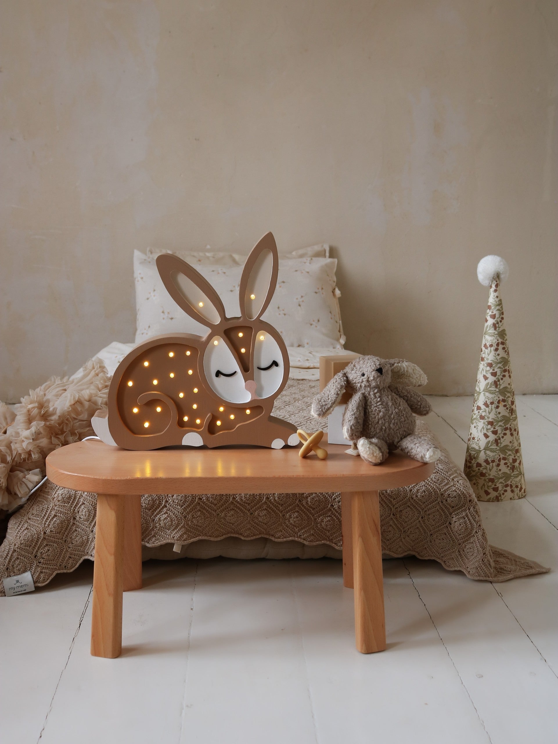 bunny lamp on a nightstand showing its adjustable dimmer and convenient timer for practical bedtime use