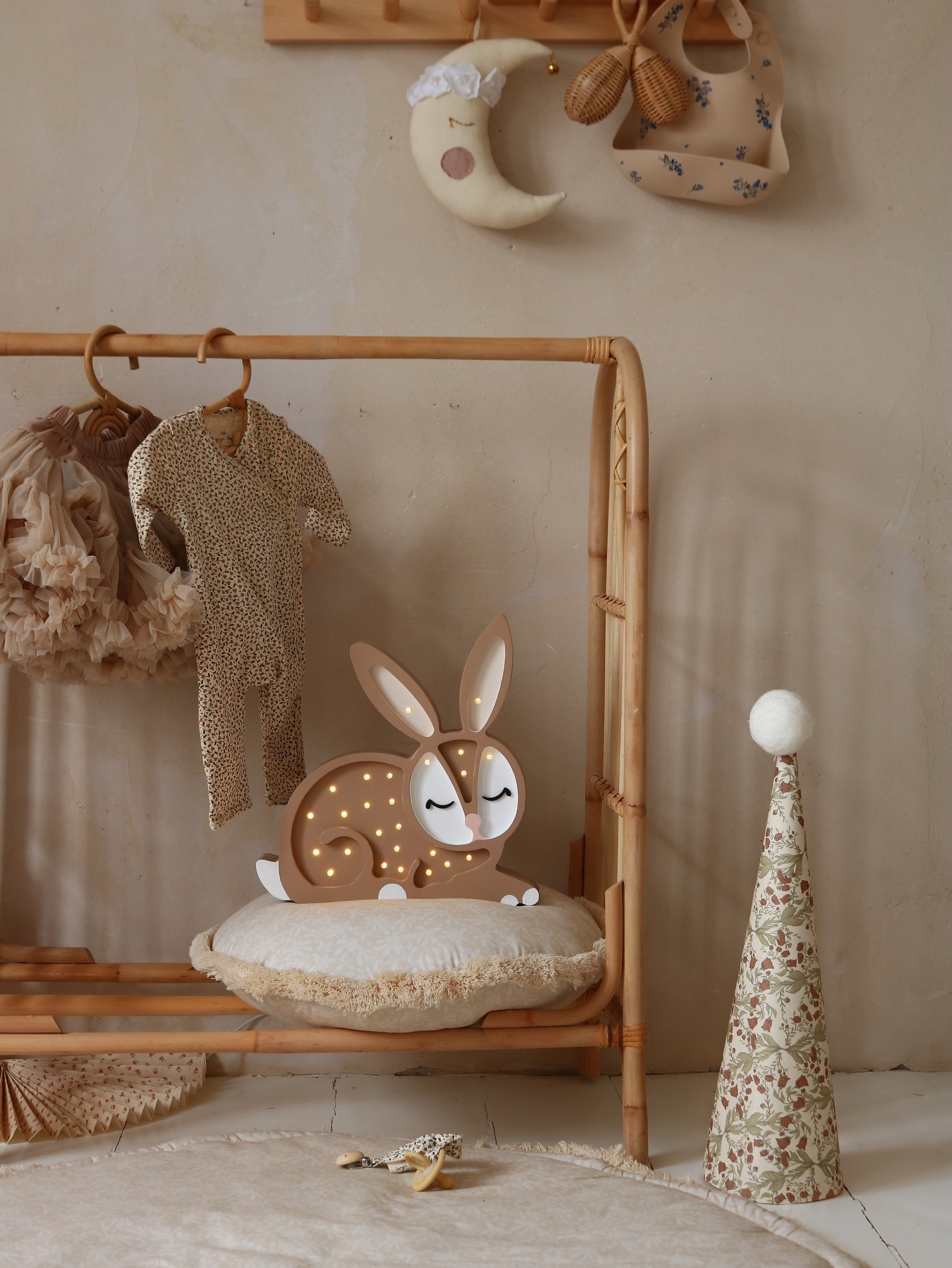 handmade solid pinewood bunny lamp casting a soft warm glow on a nursery shelf