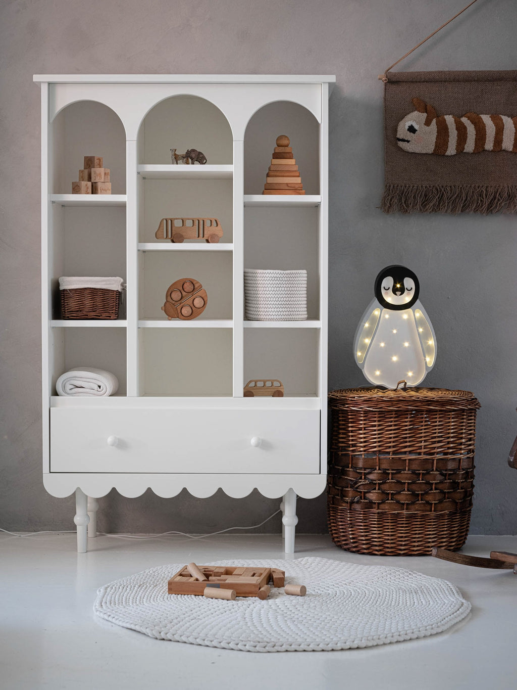 handmade pinewood penguin lamp casting a warm glow on a childs bedside table