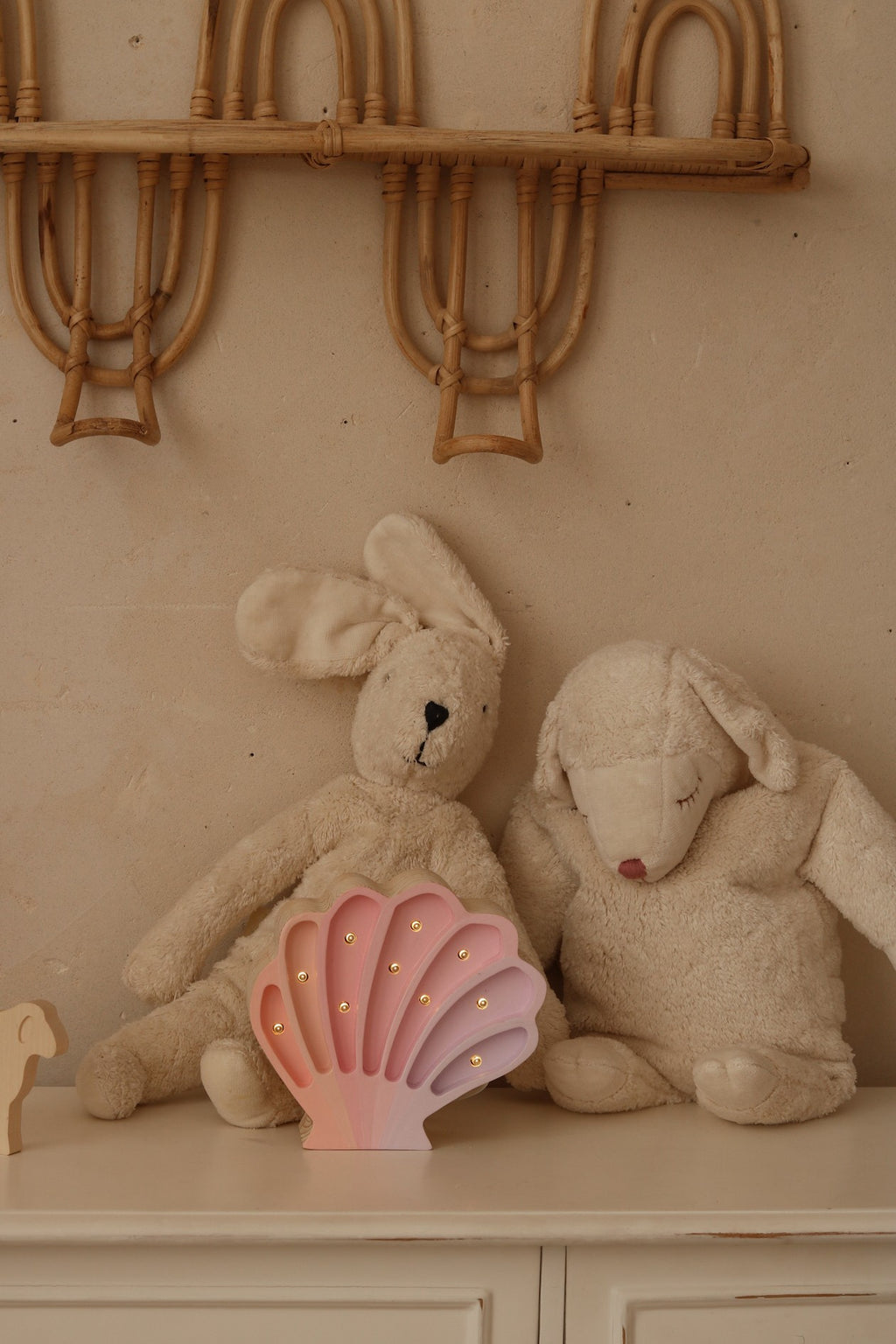 practical close-up of the seashell lamp's dimmer switch and timer settings on natural pine wood